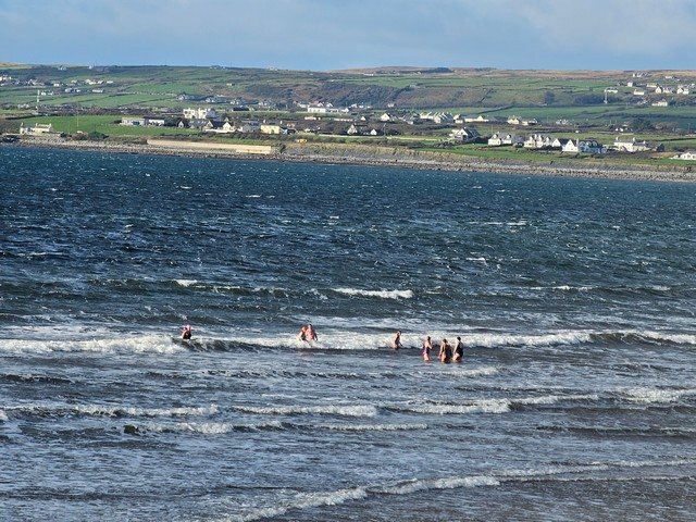 A few brave dippers in the shallows 